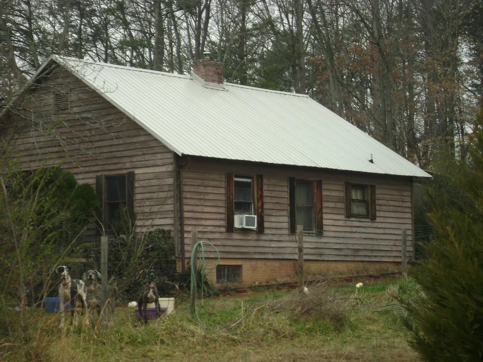 White metal roof on an old wood sided farmhouse, from a Metal Roof Installation job in Rebecca